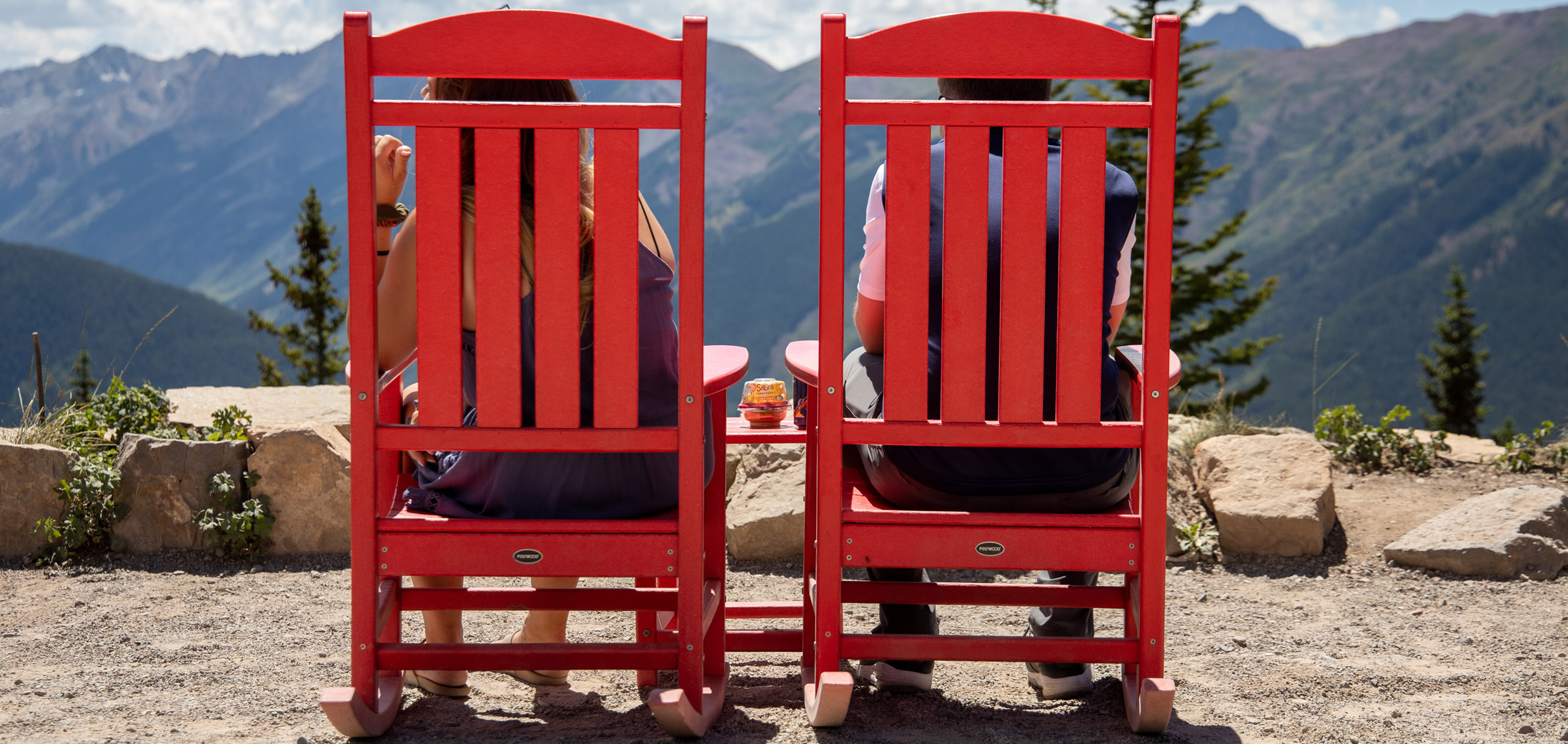 Relaxing on top of Aspen mountain in red rocking chairs